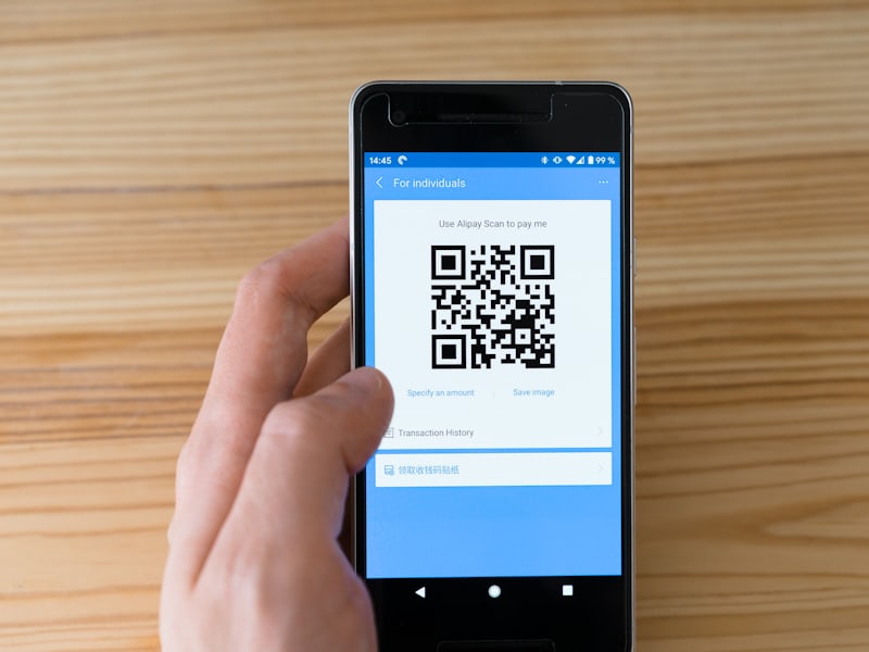 A traveller checking a saved QR pass on a phone outside a museum